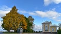 The yellow leaves trees and white beautiful houses bythe Baltic sea in autumn.