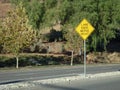 Yellow Left Lane Ends Merge Right Sign on center divider. Royalty Free Stock Photo