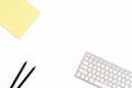 Yellow legal pad, two black pencil and keyboard on a white background. Flat lay. Top view. Royalty Free Stock Photo