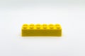 Yellow lego brick or block isolated on white background