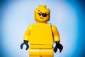 yellow lego figure with an angry face on a blue background