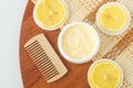 Yellow lemon facial mask banana face cream, shea butter hair mask, body butter in the small white container. Natural skin care Royalty Free Stock Photo