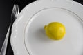 Yellow lemon on plate. top view.