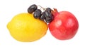 Yellow lemon, red pomegranate and dark purple ripe grapes isolated on white background. Ingredients for salad Royalty Free Stock Photo