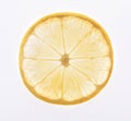 Yellow lemon slice backlit, isolated on white