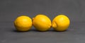 Yellow lemons on dark gray background Royalty Free Stock Photo