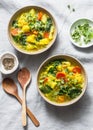 Yellow lentils and vegetables potatoes, carrots, cauliflower, turnips and turmeric thick vegetarian soup on light background,