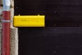 yellow letterbox on dark wooden door