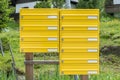 Yellow letterbox made of tin without name in a rural area, Austria