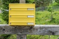 Yellow letterbox made of tin without name in a rural area, Austria