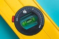 Yellow level tool on blue background. A tubular spirit level close-up. Royalty Free Stock Photo