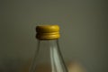 Yellow lid on a glass bottle. Glass water bottle