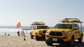 Yellow lifeguard car, beach near Los Angeles. Rescue Toyota pick up truck, lifesavers California USA