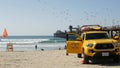 Yellow lifeguard car, beach near Los Angeles. Rescue Toyota pick up truck, lifesavers California USA