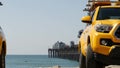 Yellow lifeguard car, ocean beach California USA. Rescue pick up truck, lifesavers vehicle.