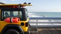 Yellow lifeguard car, ocean beach California USA. Rescue pick up truck, lifesavers vehicle.