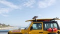 Yellow lifeguard car, ocean beach California USA. Rescue pick up truck, lifesavers vehicle.