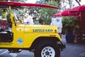 Yellow Lifeguard Jeep, rescue vehicle with surfboard at Laguna Beach in United States