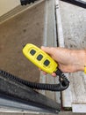 Yellow Liftgate Remote Control Held Near Truck Platform Royalty Free Stock Photo