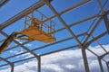 Yellow lifting platform for construction in the construction of Royalty Free Stock Photo