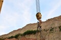 Yellow lifting telescopic arms with hook mobile crane on a background of blue sky. Royalty Free Stock Photo