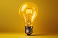 Yellow Light bulb on yellow background. top view. minimal concept Royalty Free Stock Photo