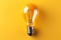 Yellow Light bulb on yellow background. top view. minimal concept Royalty Free Stock Photo