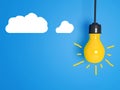 Yellow light bulb on blue background. Royalty Free Stock Photo