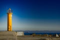 Yellow lighthouse on breakwater dam Royalty Free Stock Photo