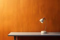 Yellow lighting retro desk lamp on old wood table with space of rough cement wall in vintage color tone Royalty Free Stock Photo