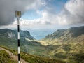 Yellow line hiking trail mark painted on a metal pole in the Bucegi Mountains, Romania