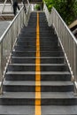 Yellow line and stairs to foot bridge. Royalty Free Stock Photo