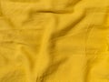 Yellow linen cloth texture pattern for abstract design Wavy natural textile backdrop Sunny color fabric blank background