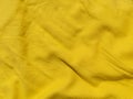 Yellow linen cloth texture pattern for abstract design Wavy natural textile backdrop Sunny color fabric blank background