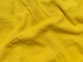 Yellow linen cloth texture pattern for abstract design Wavy natural textile backdrop Sunny color fabric blank background