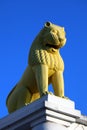 Yellow lion statue isolated on blue sky background. A lion statue at Dhauli Shanti Stupa in Odisha, India.