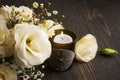 Yellow lisianthus flowers and lit candle