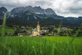 Yellow local church in Ellmau. Village of Going. Wilden Kaiser mountains in background. Tirol, Alps, Austria Royalty Free Stock Photo