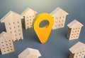 Yellow location indicator among houses. Delivery. Tracking and navigation. Internet of things, city management and city services