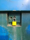 Yellow lock locking blue iron board Royalty Free Stock Photo