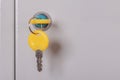 Yellow locker key close up .Keys stuck in a lock.Metal gray locker storage.Selective focus.Concept of security Royalty Free Stock Photo