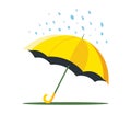 a yellow lonely umbrella lies on the ground and it is raining from the sky.