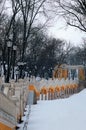 Yellow long staircase with vintage lanterns at winter. They connect Column of Magdeburg Law with Volodimirsky descent uzvoz