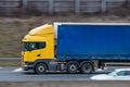 Yellow lorry with blue trailer