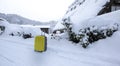 Yellow luggage on the road with snow as background