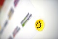 Yellow magnet with smiley face on flipchart