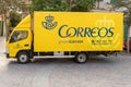 Yellow mail delivery truck parked on a street