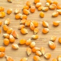 Yellow maize corn kernels ready for making popcorn, on bamboo cutting board Royalty Free Stock Photo