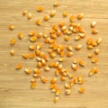 Yellow maize corn kernels ready for making popcorn, on bamboo cutting board Royalty Free Stock Photo