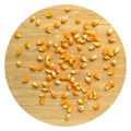 Yellow maize corn kernels ready for making popcorn, on bamboo cutting board Royalty Free Stock Photo